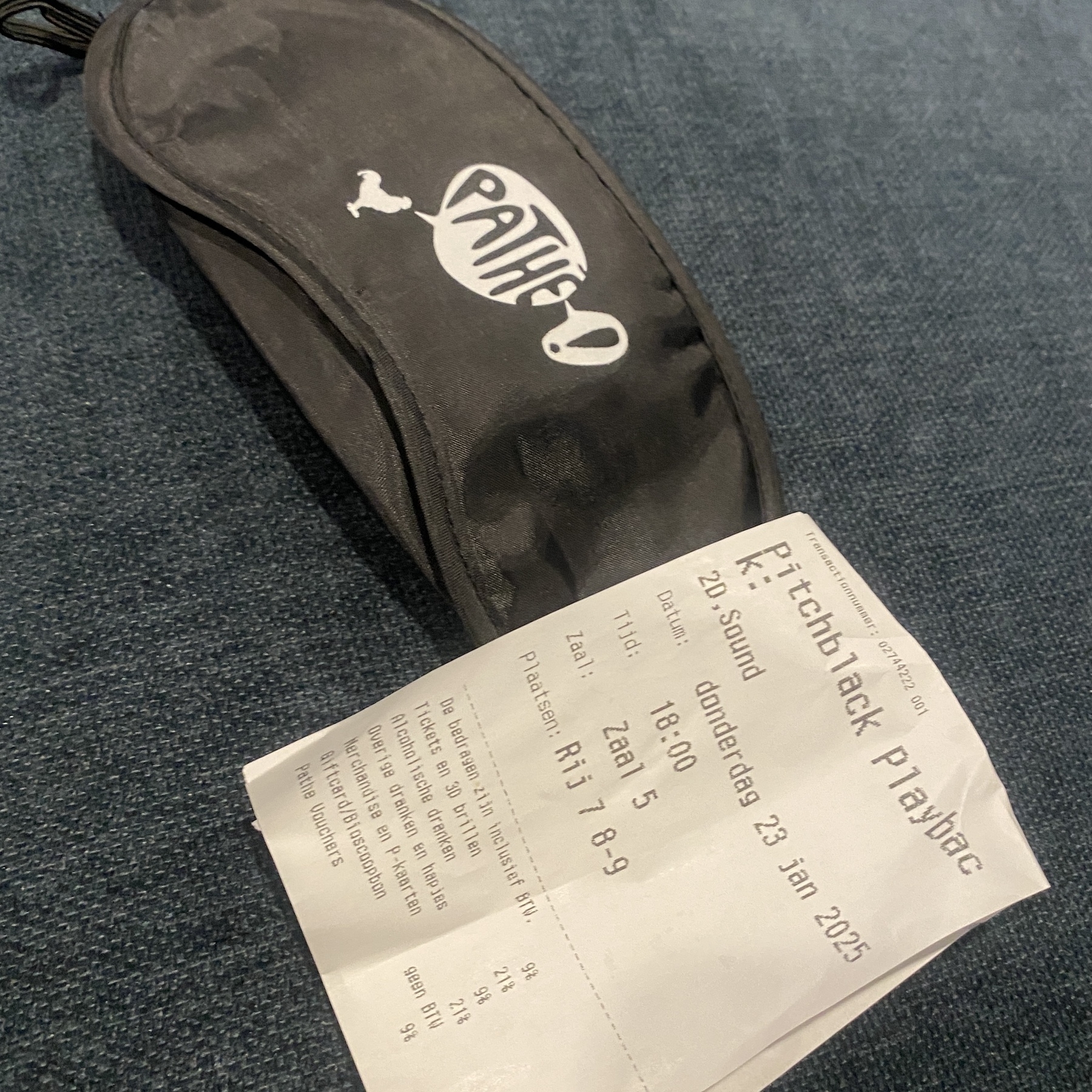 A sleeping mask and receipt for movie tickets